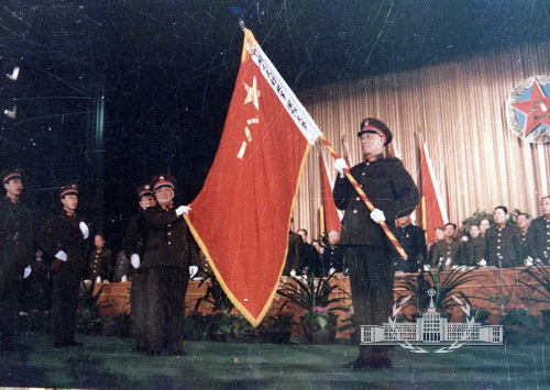1985年12月11日,中国人民解放军国防大学在北京成立。图为中央军委常务副主席杨尚昆向校长张震授旗。