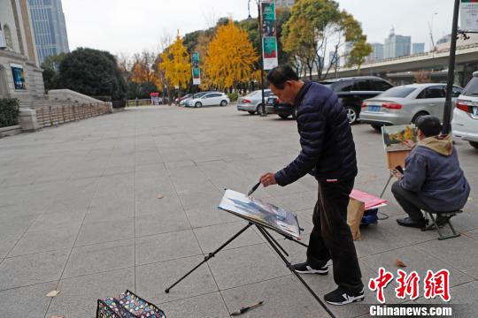 民众在上海音乐厅广场上绘画这美丽的场景。 殷立勤 摄